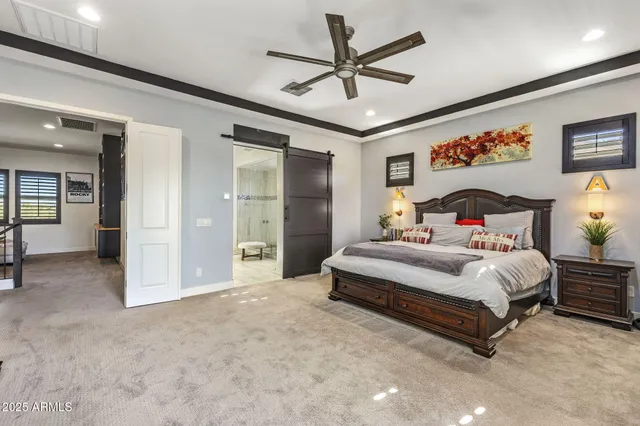 a spacious bedroom with a bed and ceiling fan