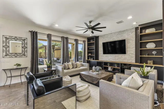a living room with furniture wooden floor and flat screen tv