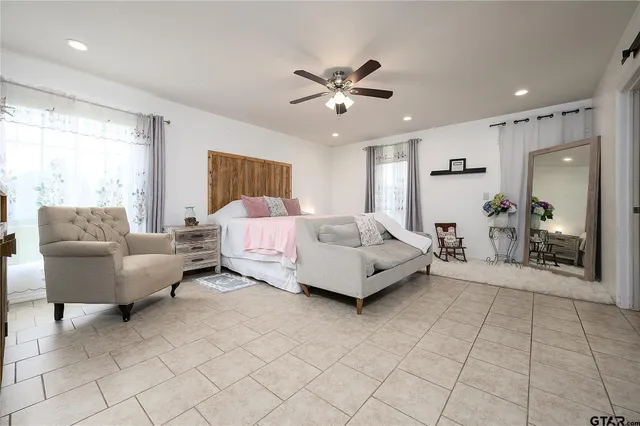 a spacious bedroom with a bed and couch