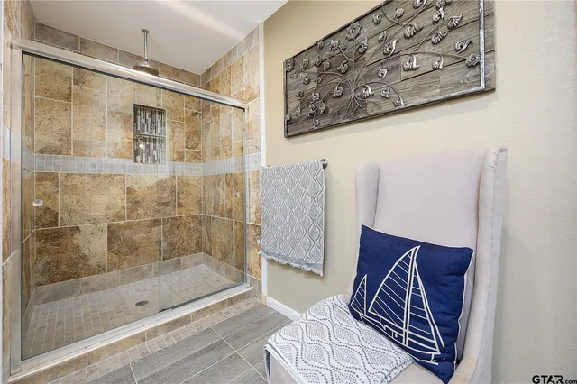 a bathroom with a bathtub and shower