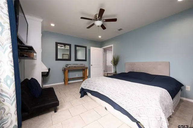 a bedroom with bed and a couch