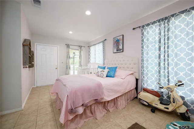 a bedroom with a bed and a window