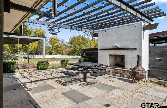 a view of a patio with a table and chairs