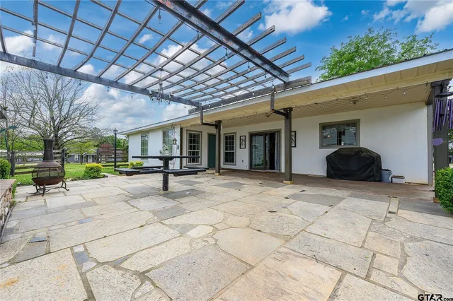 a view of a patio with table and chairs and potted plants