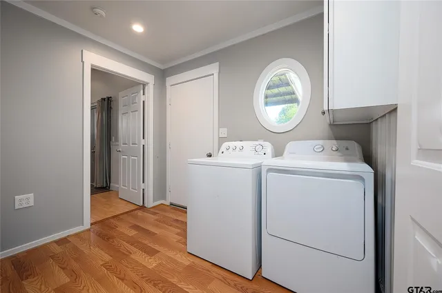 a view of washer and dryer with bathroom in the background