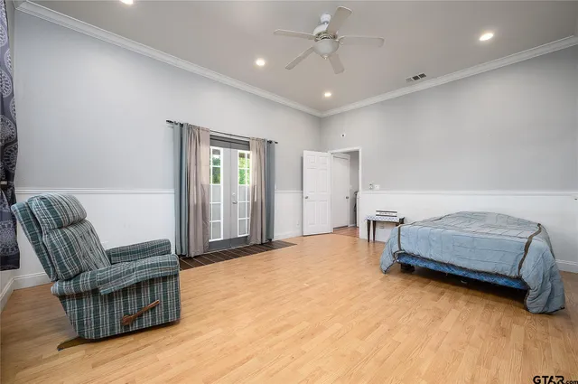 a bedroom with furniture and wooden floor