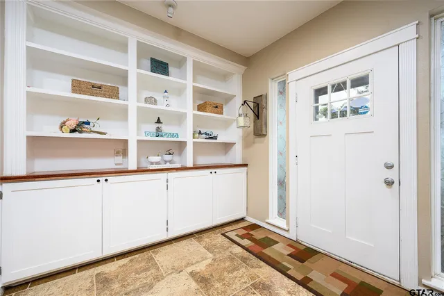 a view of kitchen with wooden floor and cabinets