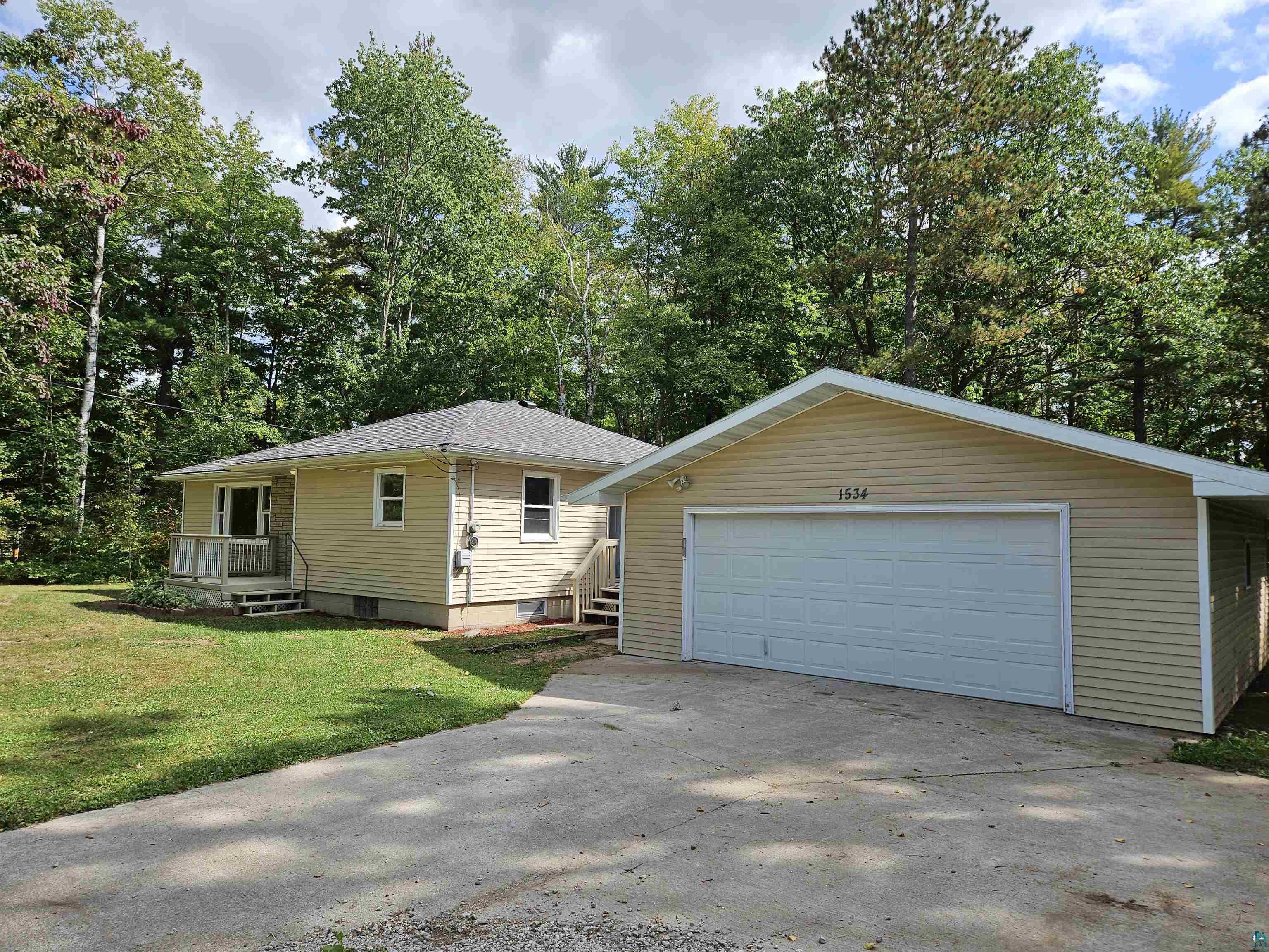 View of front of property with a garage and a front yard