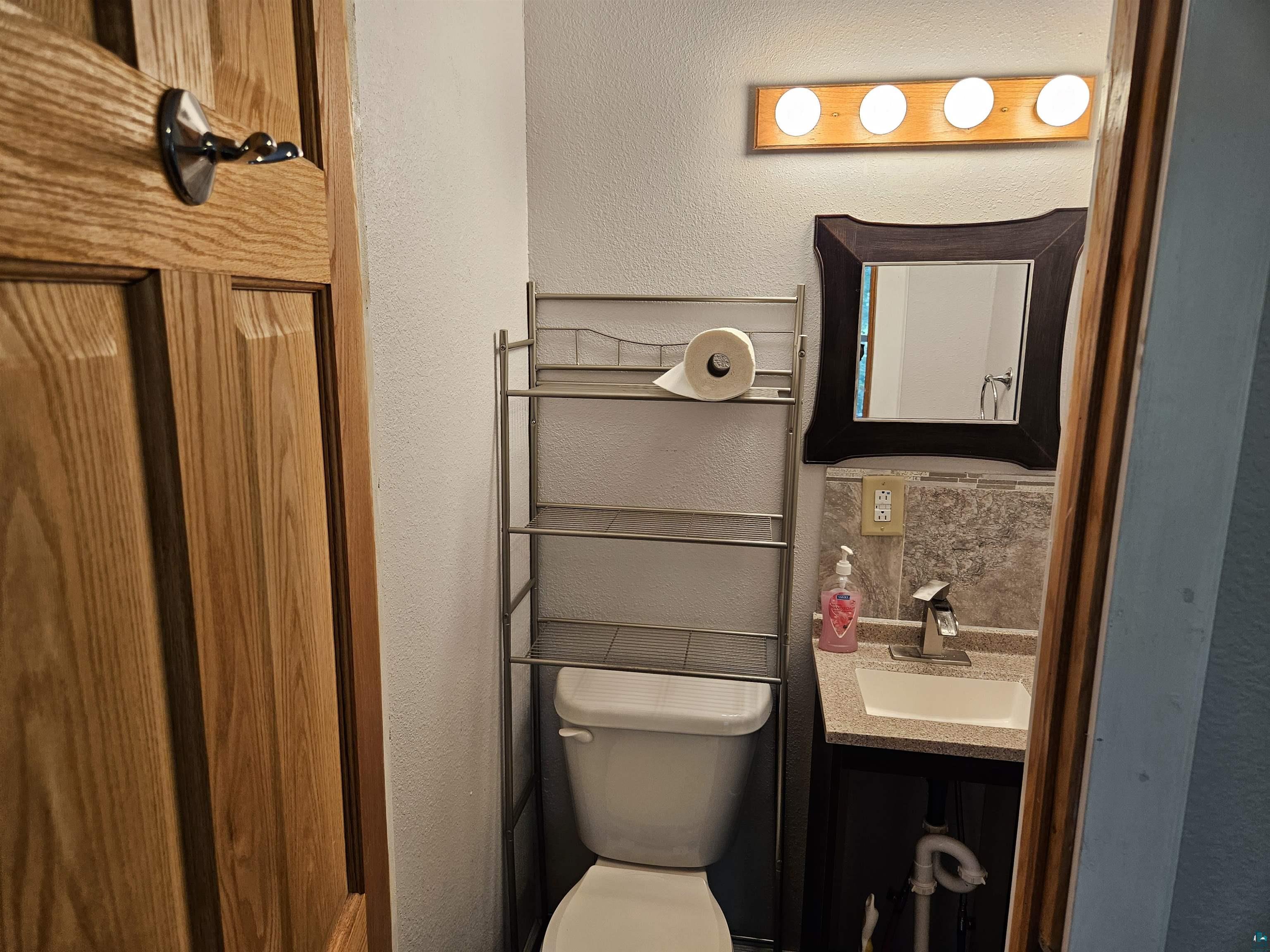 1534 Moorhead Road Cloquet, MN 55720 - Photo 14 of 16 Bathroom featuring vanity and toilet