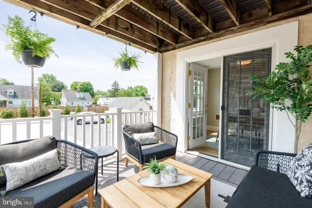 a view of a porch with furniture and a potted plant