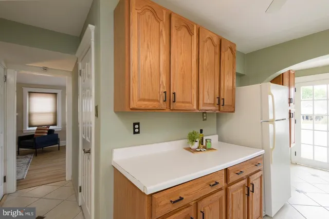 a kitchen with a sink cabinets and a window