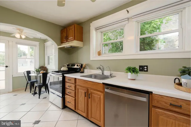 a kitchen with a sink cabinets and window