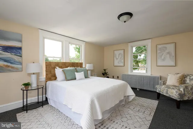 a bedroom with a bed and a couch