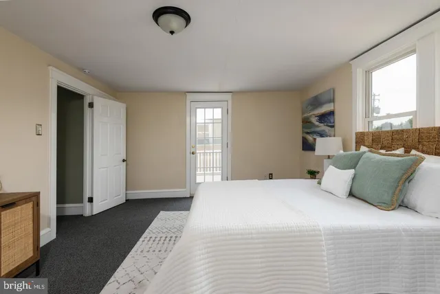 a bedroom with a large bed and a chandelier