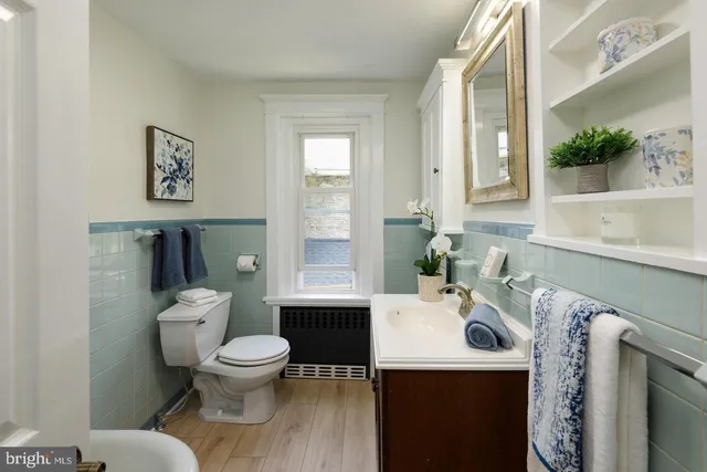 a white toilet sitting next to a bathroom sink