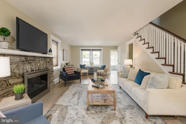 a living room with furniture a flat screen tv and a fireplace
