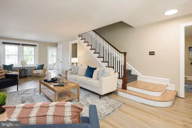 a living room with furniture and wooden floor