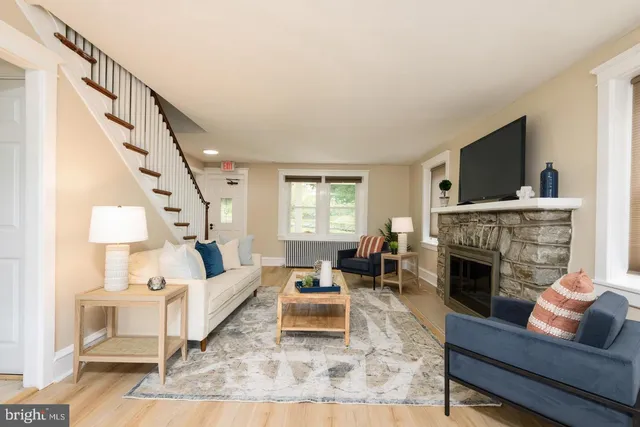 a living room with furniture fireplace and flat screen tv