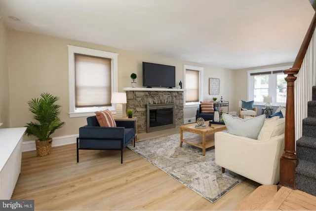 a living room with furniture a flat screen tv and a fireplace