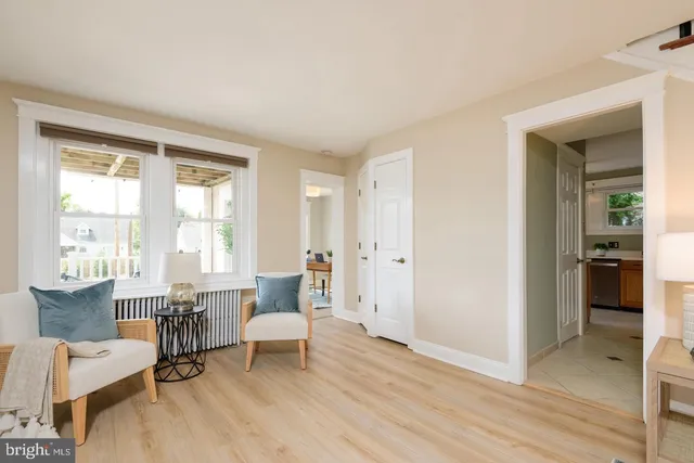 a living room with furniture a dining table and a large window