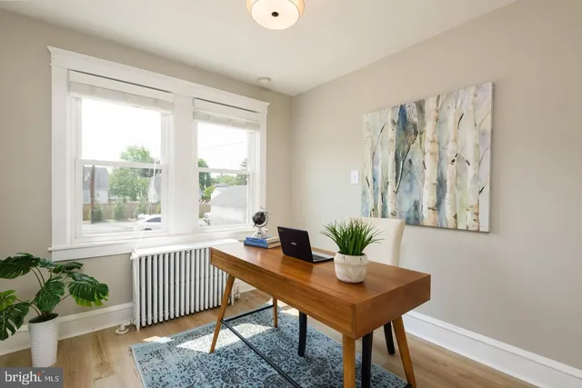 a view of a room with a table and a potted plant