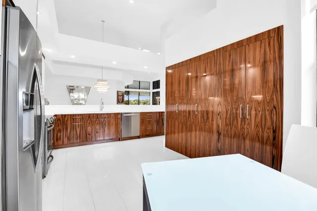 a bedroom with a large bed and a chandelier