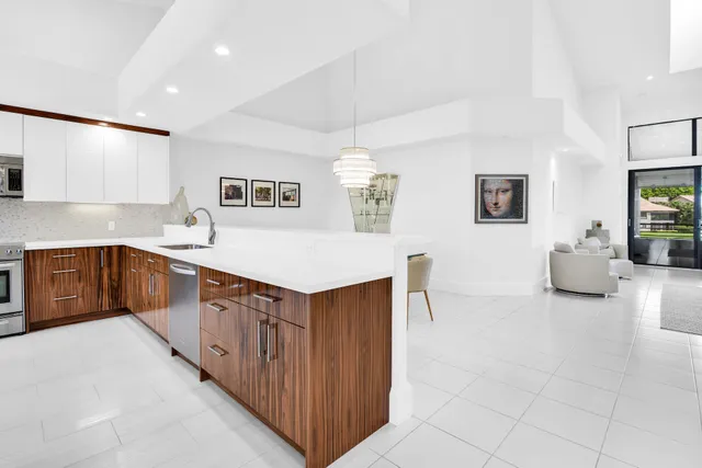 a kitchen with stainless steel appliances a sink stove and cabinets