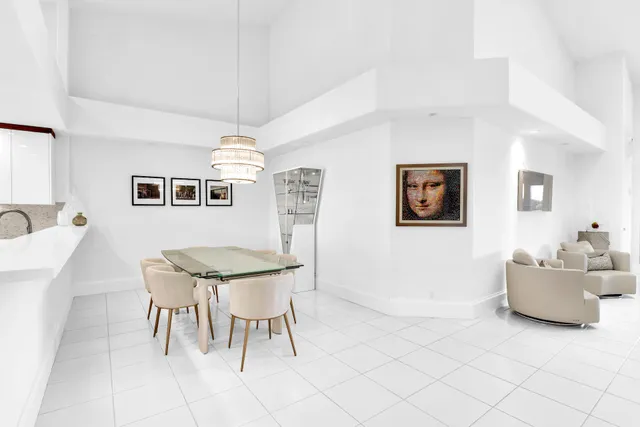 a living room with furniture and a dining table with white walls