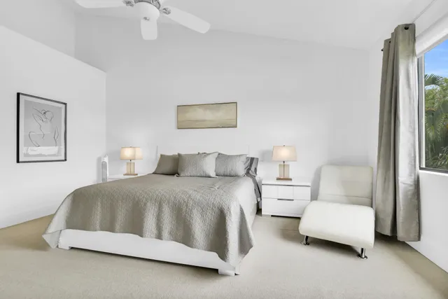 a spacious bedroom with two beds and a large mirror