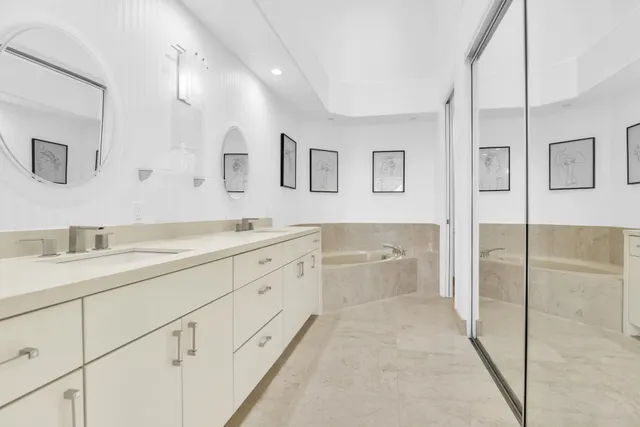 a spacious bathroom with a granite countertop sink a toilet a mirror and shower
