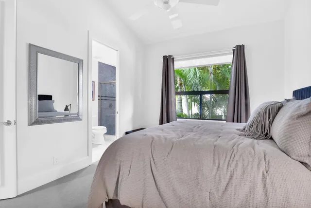 a bedroom with a bed and a large window