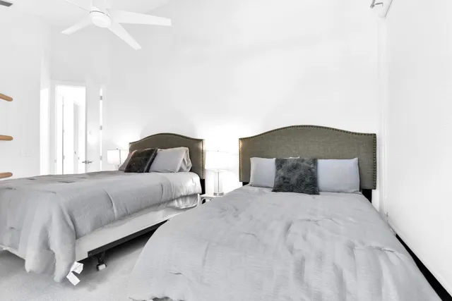 a bedroom with a bed and a night stand