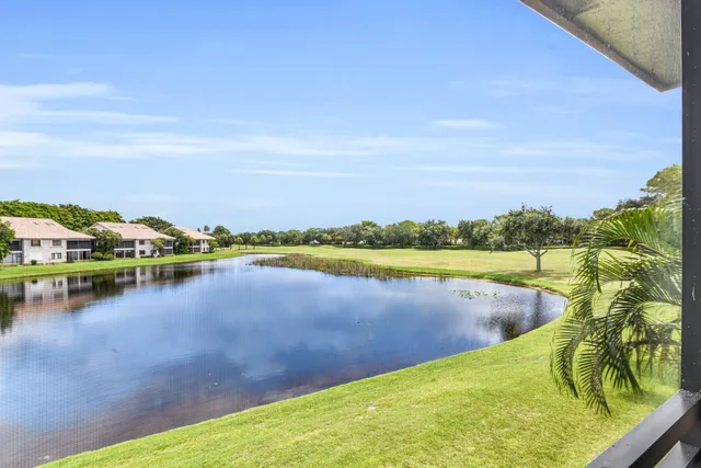 a view of a lake with houses in the back