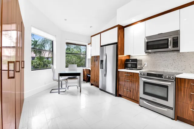 a kitchen with stainless steel appliances a stove a microwave and a refrigerator
