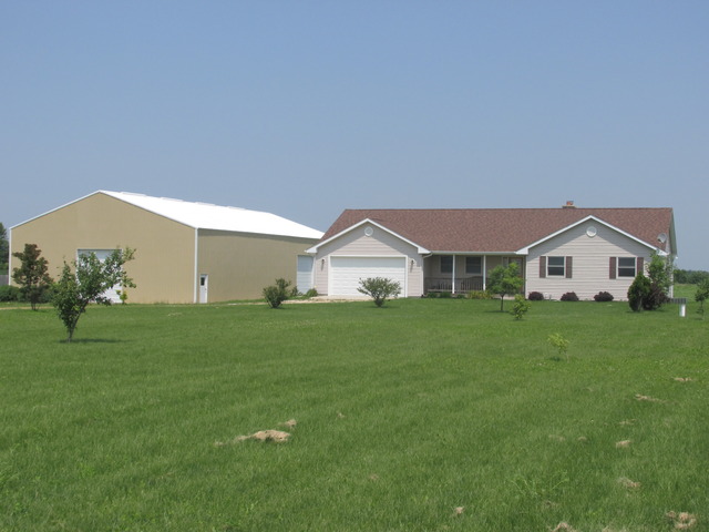 3392 Dredge Road Paw Paw, IL 61353 - Photo 1 of 18 a front view of a house with garden