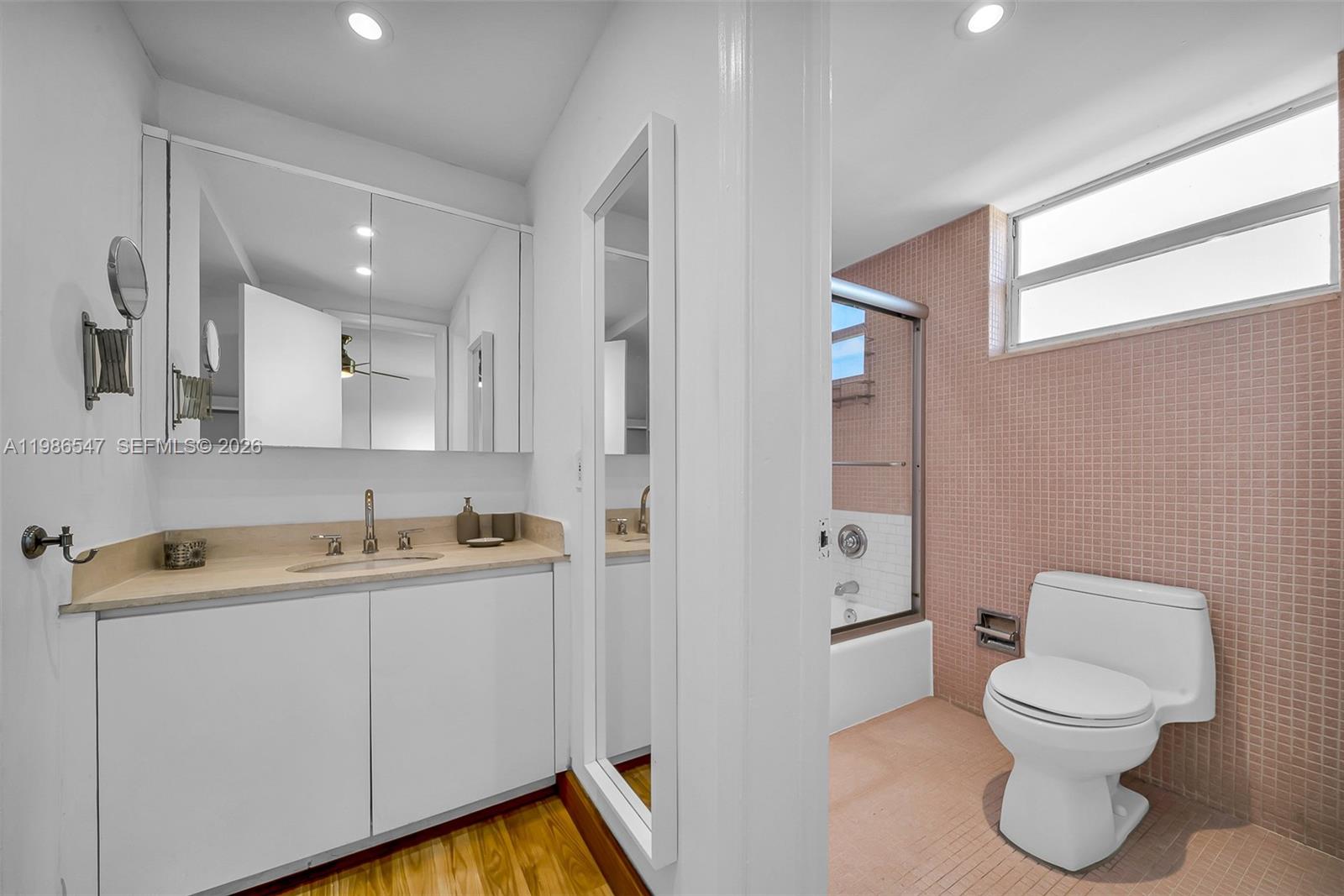 555 Crandon Boulevard, Unit 53 Key Biscayne, FL 33149 - Photo 11 of 23 a bathroom with a toilet sink and mirror