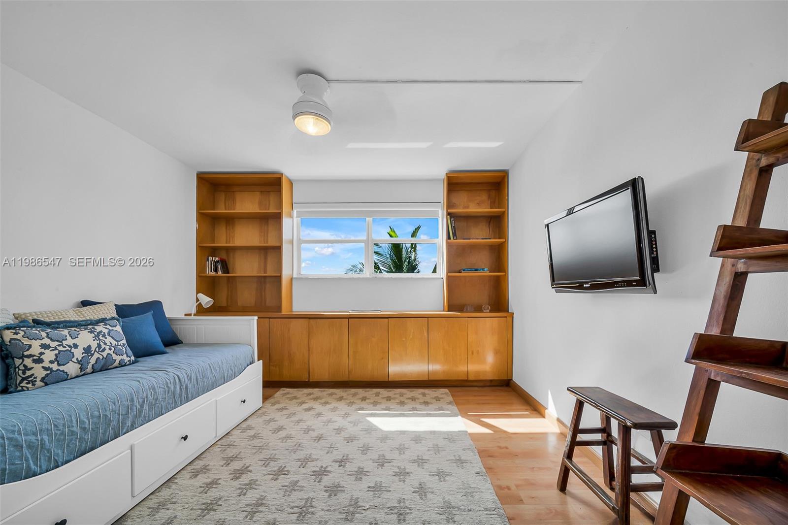 555 Crandon Boulevard, Unit 53 Key Biscayne, FL 33149 - Photo 13 of 23 a living room with furniture and a flat screen tv