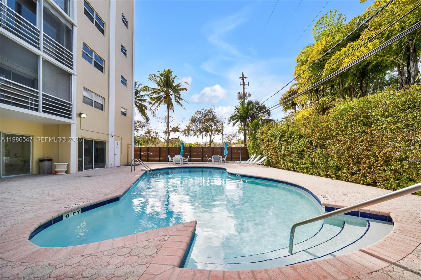 555 Crandon Boulevard, Unit 53 Key Biscayne, FL 33149 - Photo 20 of 23 a view of a swimming pool with a yard