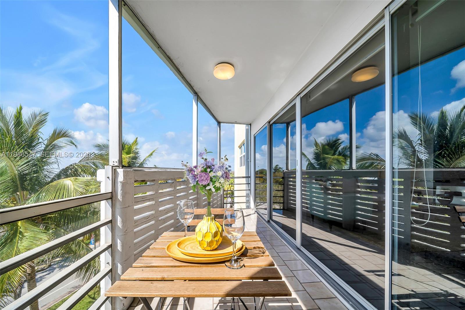 555 Crandon Boulevard, Unit 53 Key Biscayne, FL 33149 - Photo 4 of 23 a view of a balcony and floor to ceiling window with wooden floor