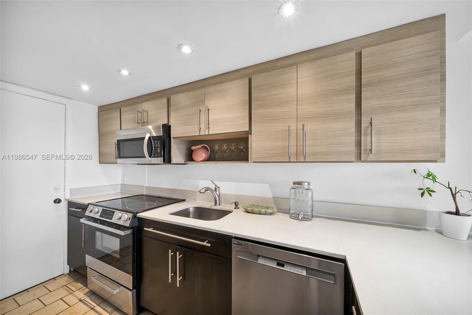 555 Crandon Boulevard, Unit 53 Key Biscayne, FL 33149 - Photo 8 of 23 a kitchen with stainless steel appliances a sink a stove and cabinets