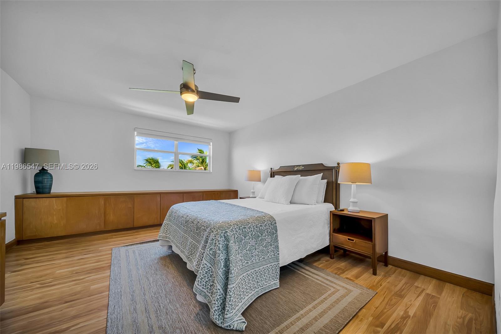 555 Crandon Boulevard, Unit 53 Key Biscayne, FL 33149 - Photo 9 of 23 a bedroom with a bed and wooden floor
