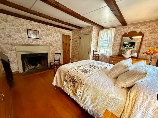 a bedroom with a bed and a fireplace