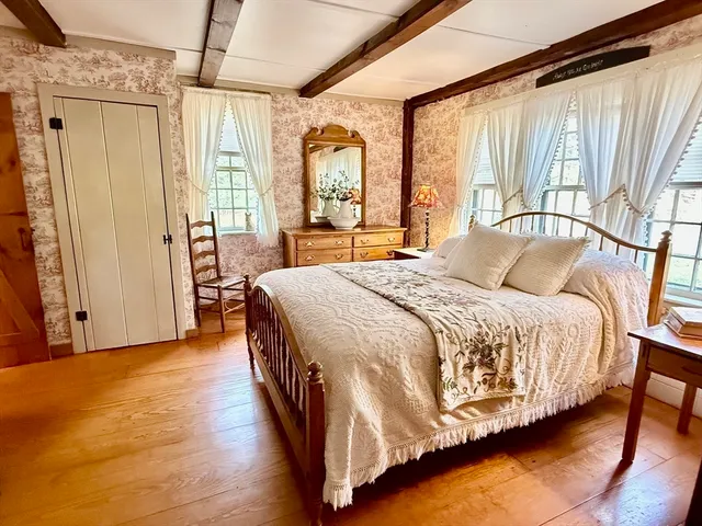 a spacious bedroom with a large bed and a large window