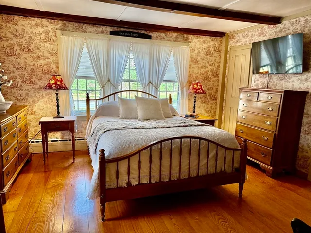 a bed sitting in a bedroom next to a window