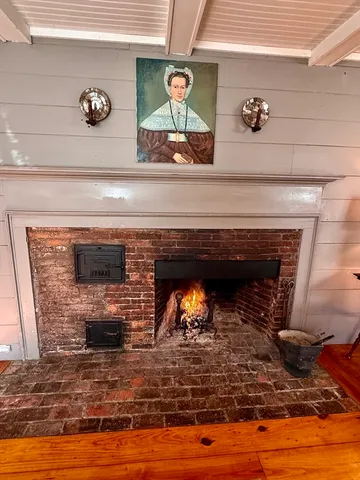 a fireplace with a clock on wall