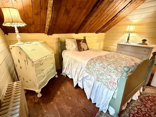 a bed room with a bed and a chair