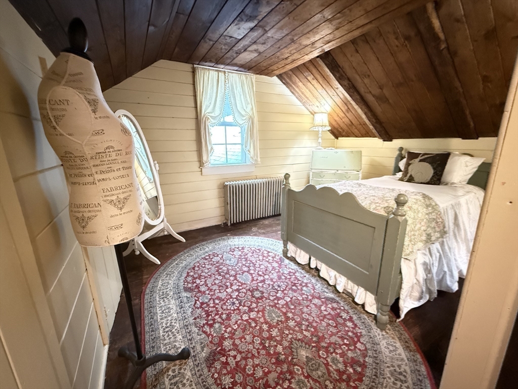 285 Brookfield Road Sturbridge, MA 01518 - Photo 26 of 42 a bed room with a bed and a chair