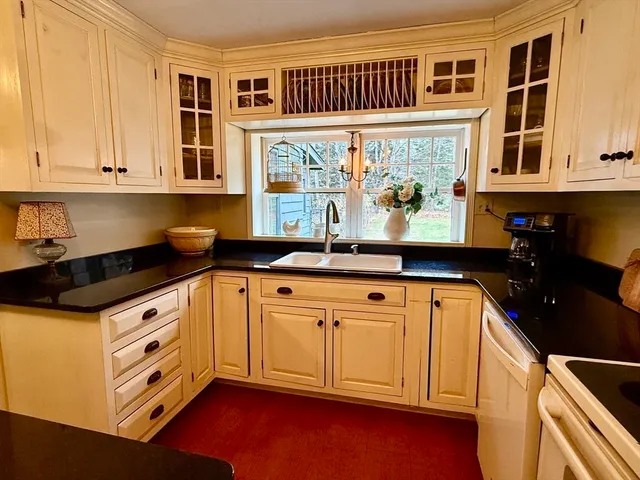 a kitchen with stainless steel appliances granite countertop a sink and cabinets