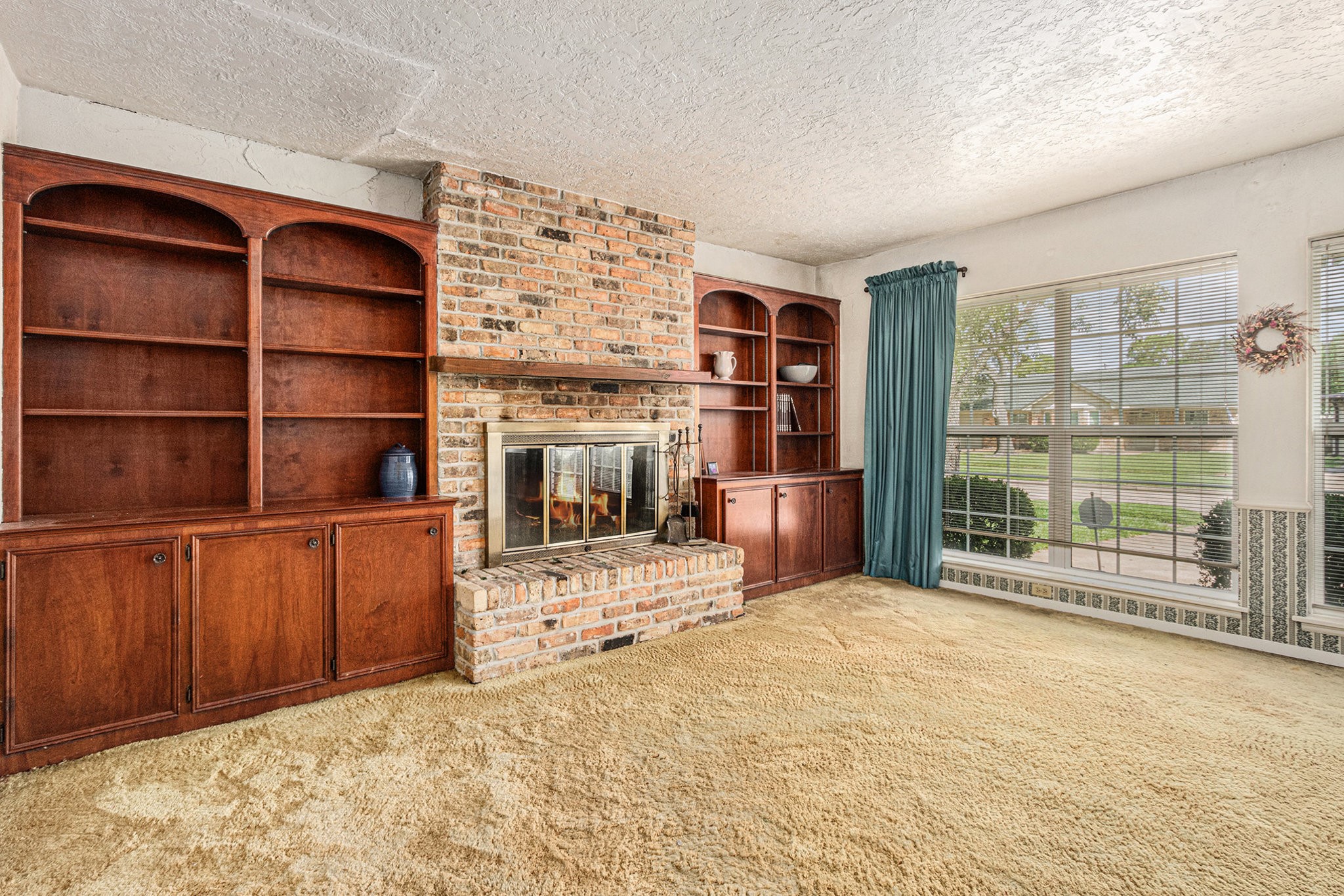 8019 Sharpview Drive Houston, TX 77036 - Photo 6 of 40 Woodburning fireplace for warmth and ambiance! Built in bookshelves - this home has a ton of storage!