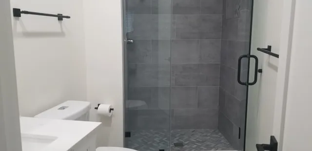 a bathroom with a shower and a sink